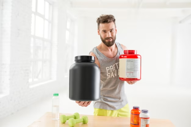 Man holding two different protein powder containers