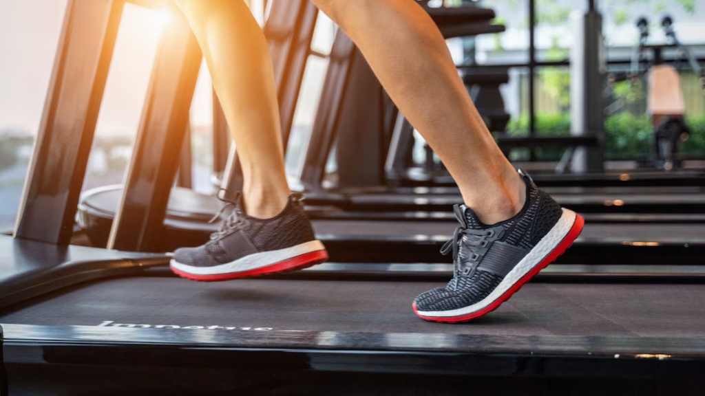 Close-up view of feet wearing sneakers on a treadmill