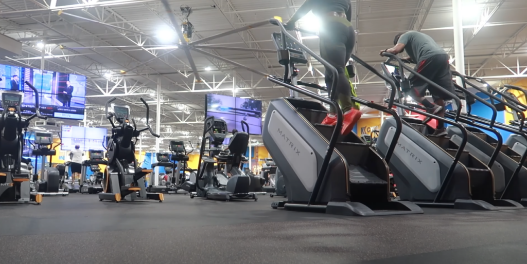 Indoor gym featuring a row of StairMaster machines
