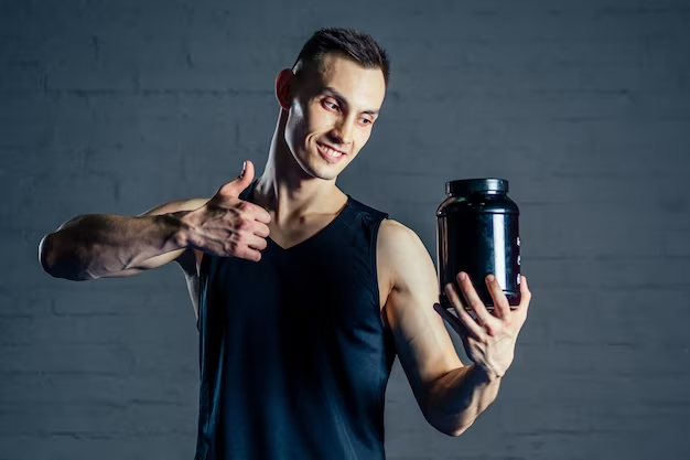 Man giving thumbs up with a protein powder container on the other hand