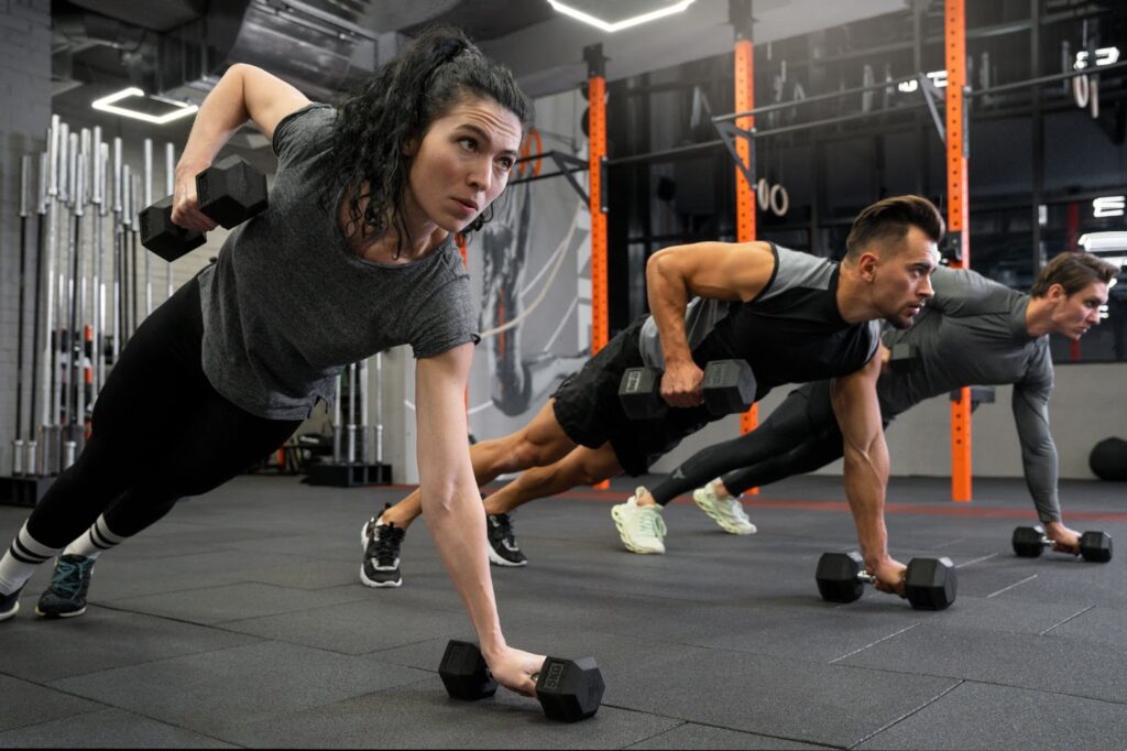 Group of people working out together with dumbbells