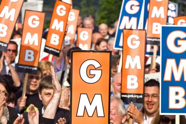 Group of people holding GMB signs
